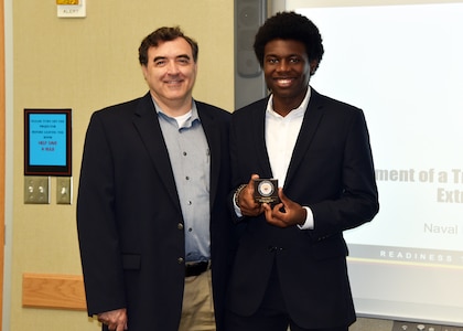 JOINT BASE SAN ANTONO-FORT SAM HOUSTON – (Aug. 9, 2023) – Pennsylvania State University sophomore William Hervey (right), of San Antonio, an Oak Ridge Institute for Science and Education (ORISE) intern with his mentor Dr. William D'Angelo, a lead biomedical engineer, assigned to Naval Medical Research Unit (NAMRU) San Antonio’s Biomedical Systems Engineering and Evaluation Department, after attending Hervey’s research presentation titled “Development of a Trauma Manikin for Test and Evaluation in Extreme Cold Environments” at the Battlefield Health and Trauma Research Institute. ORISE is a U.S. Department of Energy asset that is dedicated to enabling critical scientific, research, and health initiatives of the department and its laboratory system by providing world class expertise in STEM workforce development, scientific and technical reviews, and the evaluation of radiation exposure and environmental contamination. NAMRU San Antonio is one of the leading research and development laboratories for the U.S. Navy under the Department of Defense (DoD) and is one of eight subordinate research commands in the global network of laboratories operating under the Naval Medical Research Command in Silver Spring, Md.  Its mission is to conduct gap driven combat casualty care, craniofacial, and directed energy research to improve survival, operational readiness, and safety of DoD personnel engaged in routine and expeditionary operations. (U.S. Navy photos by Burrell Parmer, NAMRU San Antonio Public Affairs)