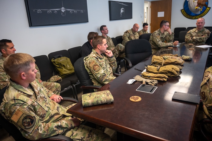 Members of the 5th Contracting Squadron hold a meeting with other squadron leaders to discuss new heated glove prototypes for base personnel at Minot Air Force Base, North Dakota, July 17, 2023. This equipment will be beneficial to the 54th HS and other Team Minot Airmen, as they experience extreme cold weather. (U.S. Air Force photo Airman 1st Class Alexander Nottingham)