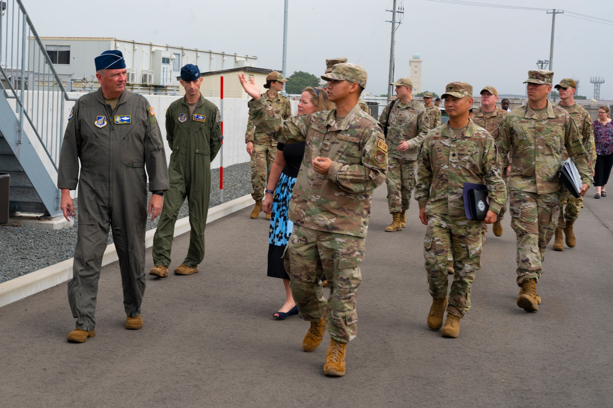 A group of people walking through a liquid natural gas plant.