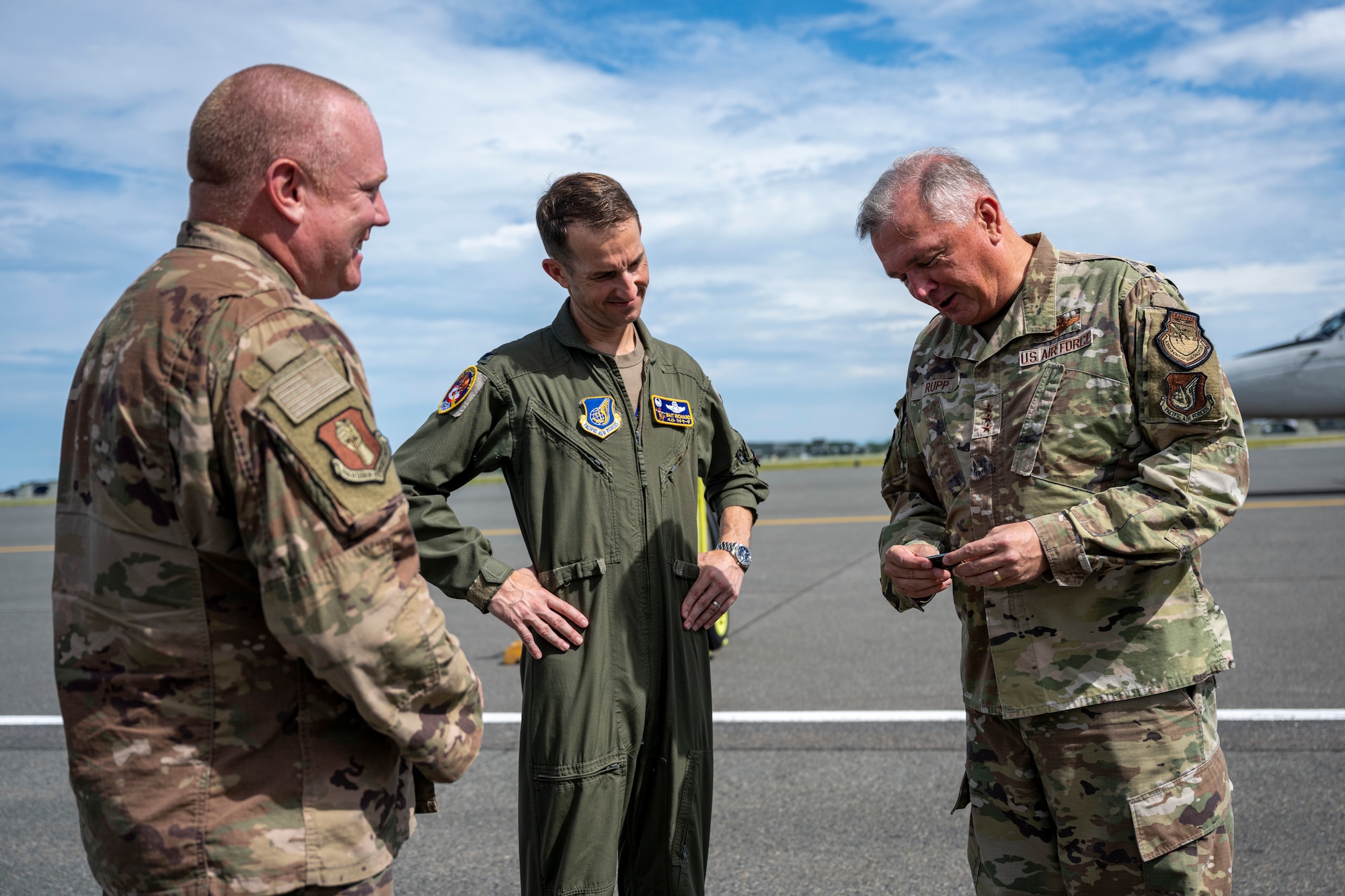 A group of people on the flightline.