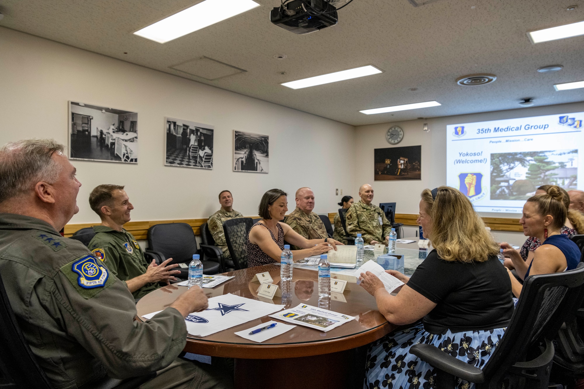 A group of people sitting around a table reviewing a power point.