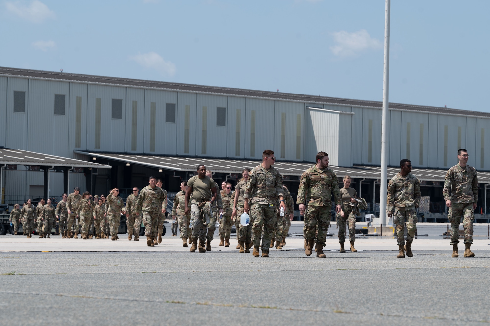 Team Dover Airmen walk toward a C-17 Globemaster III parked on the flightline for MEDIC-X training held at Dover Air Force Base, Delaware, Aug. 9, 2023. MEDIC-X is the Air Force Surgeon General’s Multi-Capable Airmen initiative to ensure all medical personnel, clinical and non-clinical, are equipped with life-sustaining skills needed for future conflicts where resources may be limited. (U.S. Air Force photo by Airman 1st Class Dieondiere Jefferies)