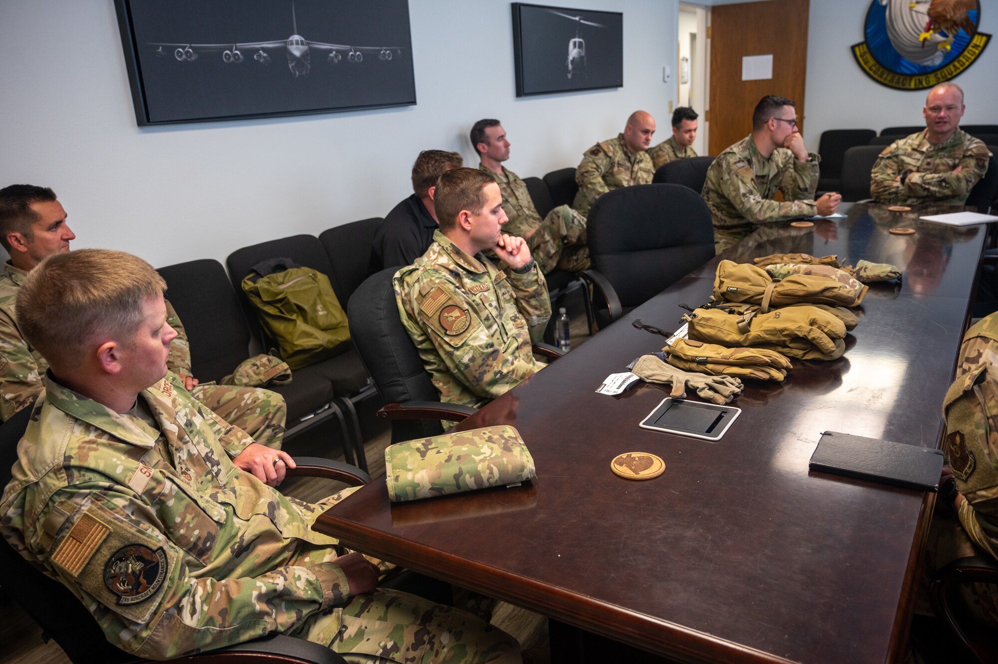 Members of the 5th Contracting Squadron hold a meeting with other squadron leaders to discuss new heated glove prototypes for base personnel at Minot Air Force Base, North Dakota, July 17, 2023. This equipment will be beneficial to the 54th HS and other Team Minot Airmen, as they experience extreme cold weather. (U.S. Air Force photo Airman 1st Class Alexander Nottingham)
