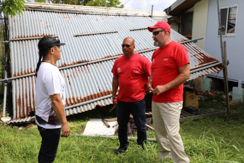 John Will (Right) and Anthony Certeza (Middle) conduct a site-visit June 27, 2023, in Mong-Mong, Guam, as part a two-person quality assessment and home inspection team responding in the aftermath of Typhoon Mawar. Certeza is a native of Guam and left the island 22 years ago for the United States. He then joined the U.S. Army Corps of Engineers Nashville District. (USACE photo by Frederick Hoyt)