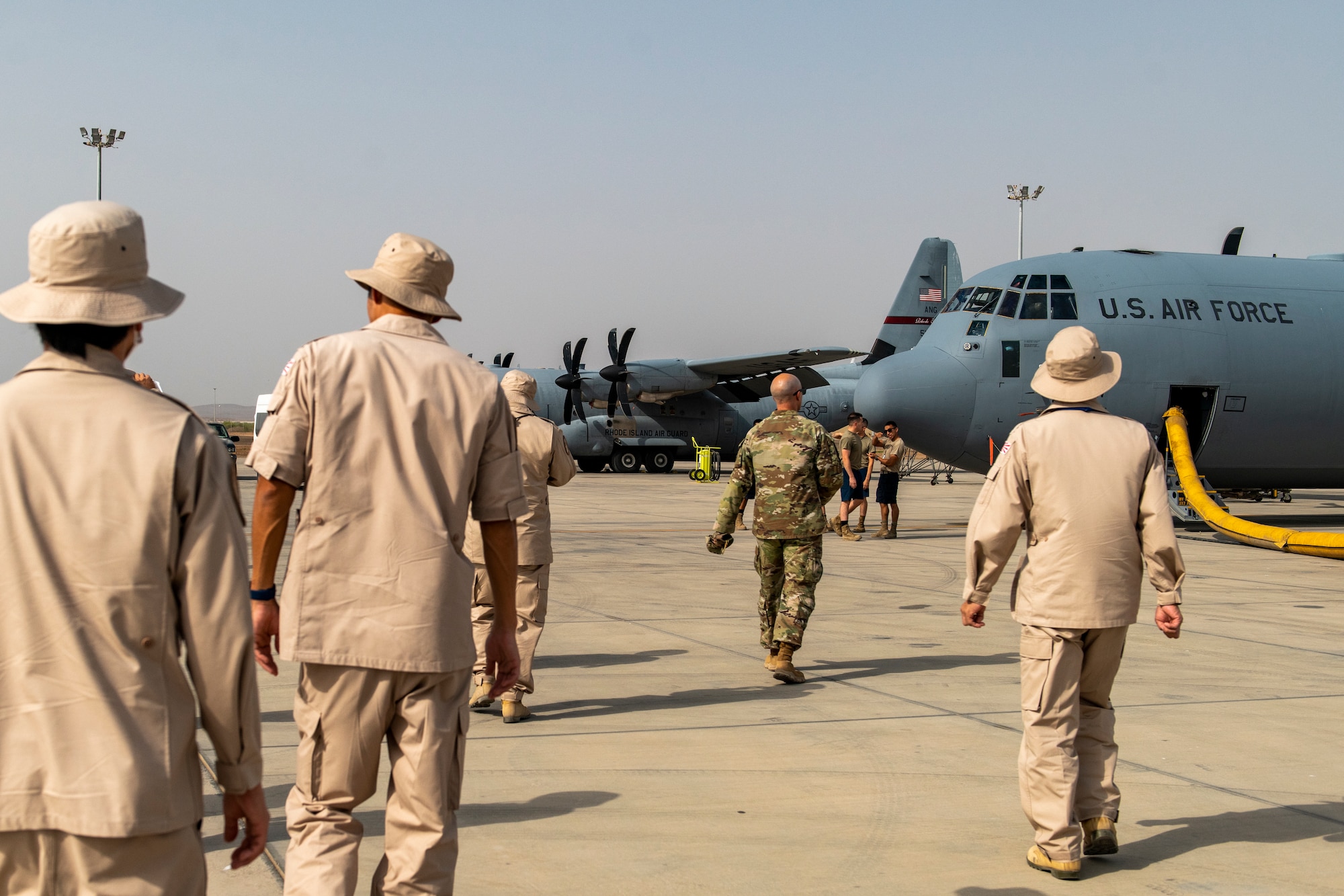 Photo of service members walking towards a cargo plane