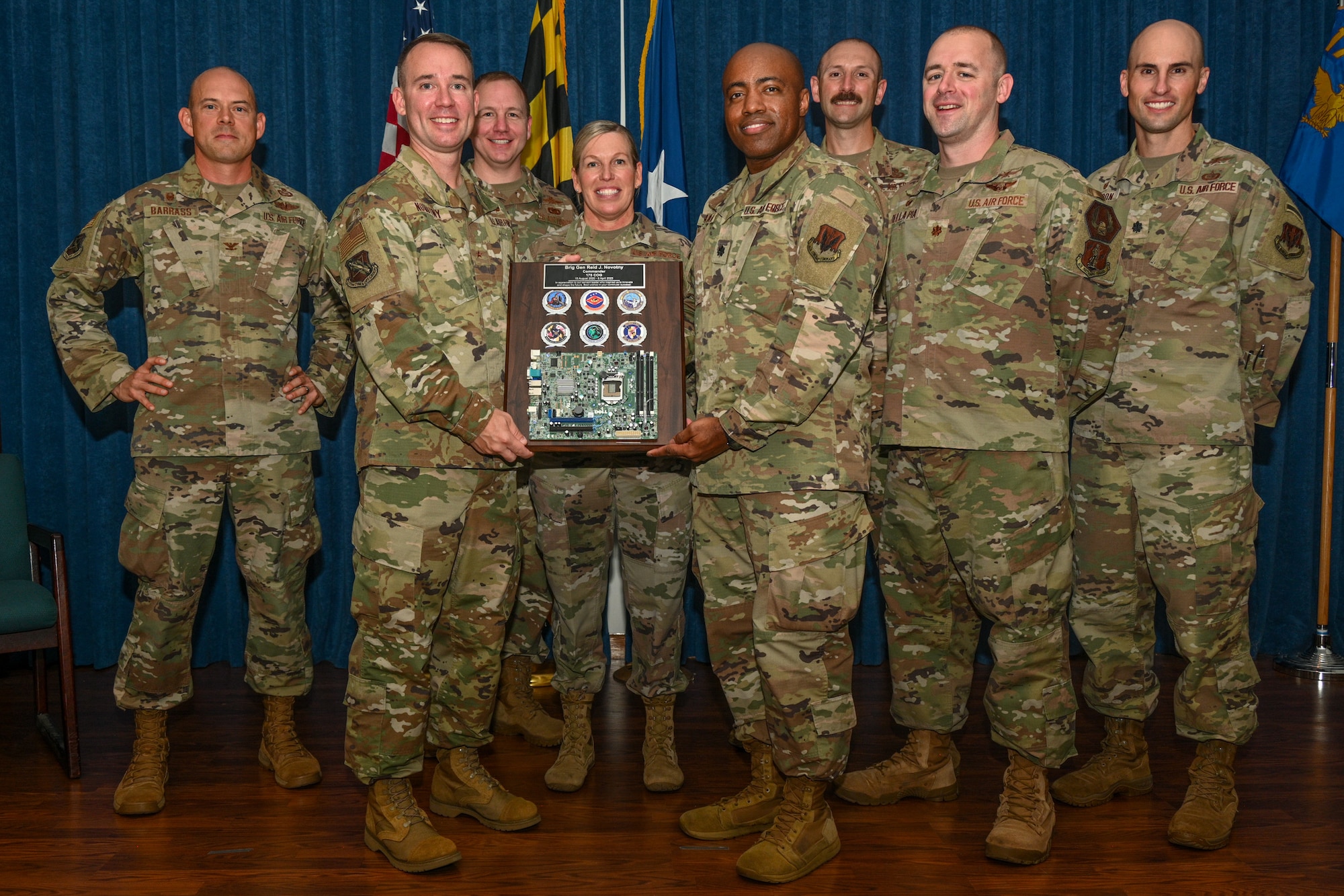 U.S. Air Force Brig. Gen. Reid Novotny, center left, 175th Cyberspace Operations Group outgoing commander, is presented with a plaque of appreciation from the 175th Cyberspace Operations Group leadership to commemorate his time as commander, August 12, 2023, at Martin State Air National Guard Base, Maryland.