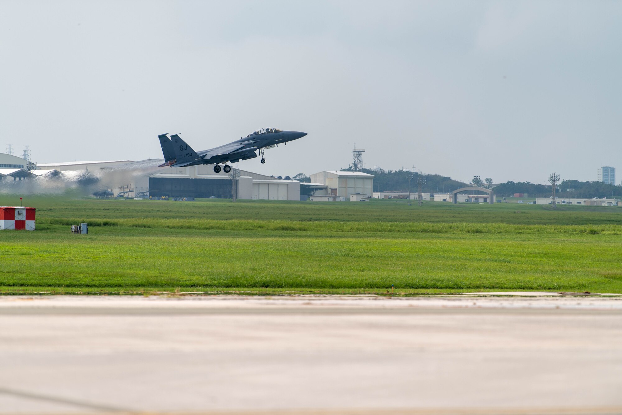 An F-15E Strike Eagle takes off from a runway.