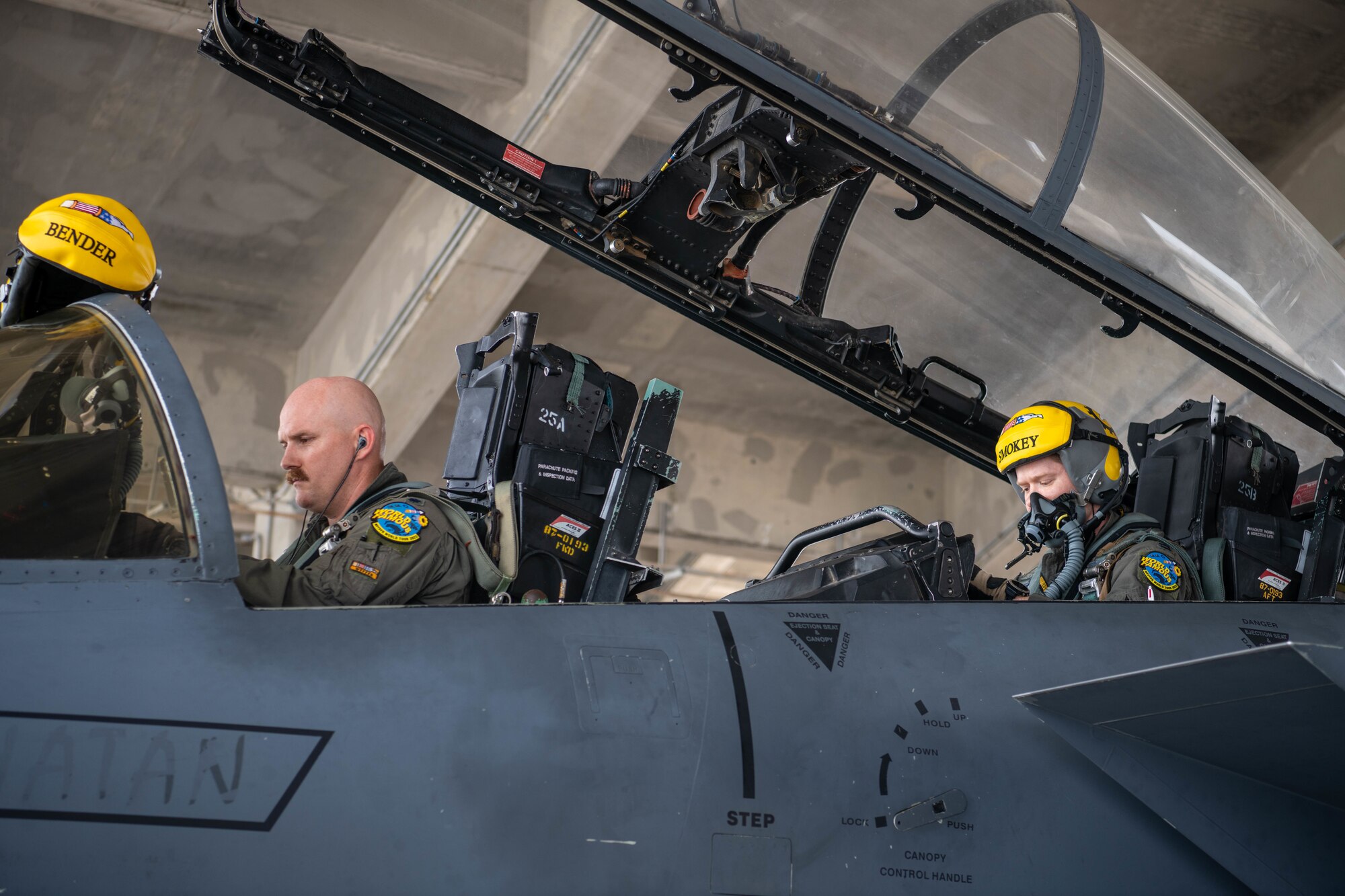 I pilot conducts pre-flight checks in an F-15E Strike Eagle cockpit
