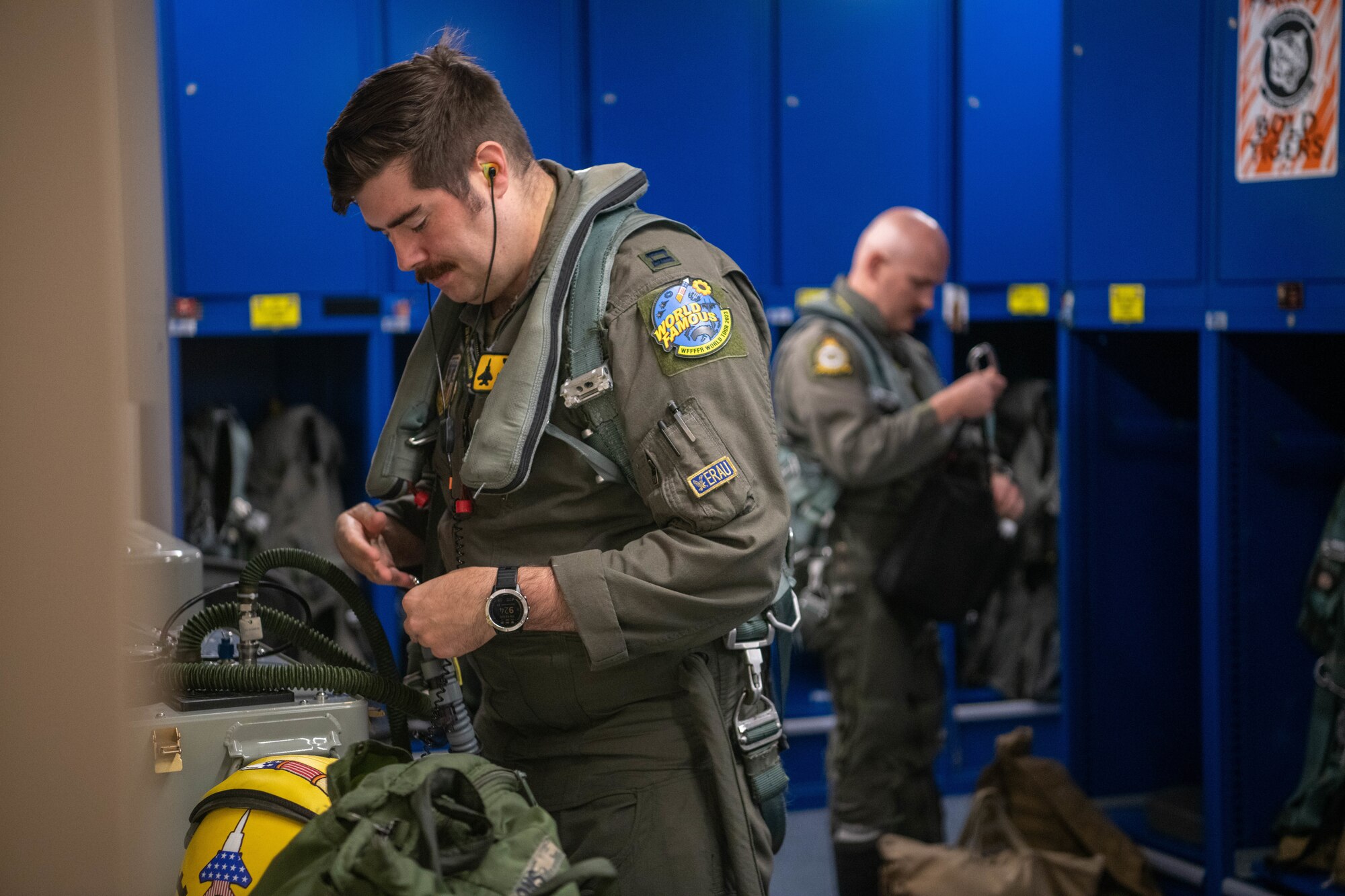 Two pilots conduct pre-flight preparations.