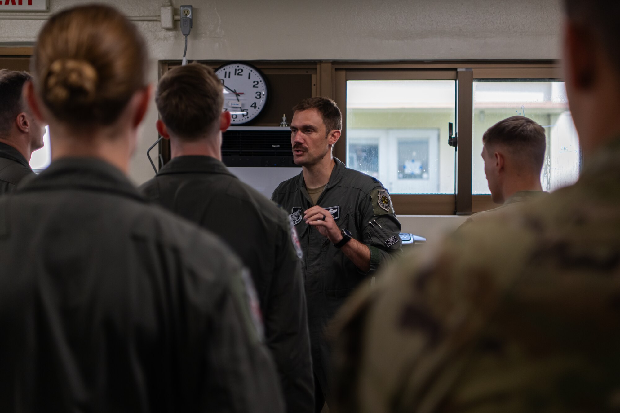 A pilot discusses flight operations with other pilots.