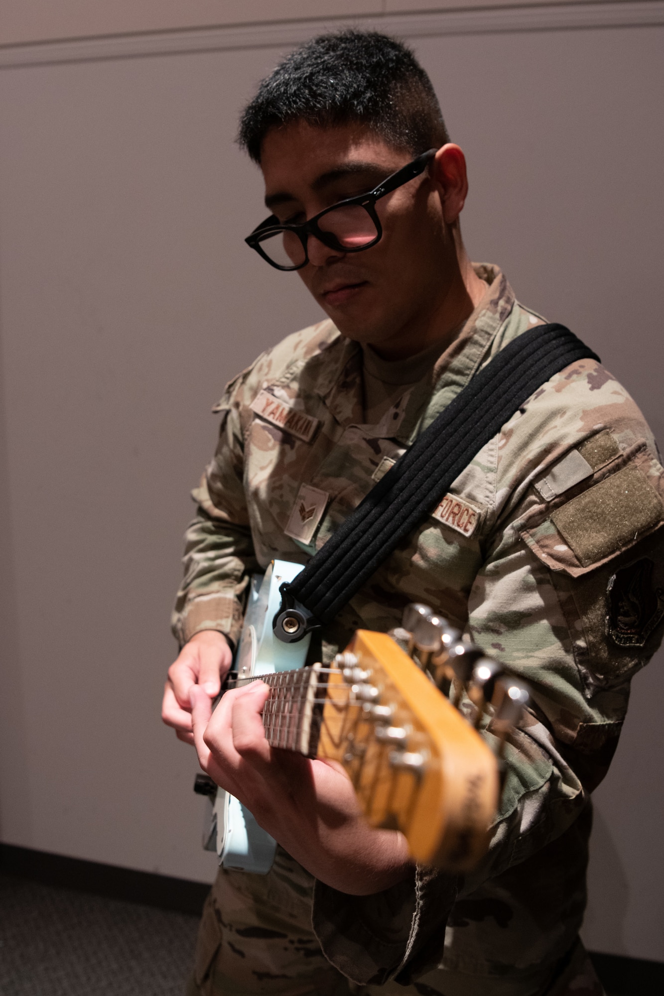 Senior Airman Ryu, Yamakawa playing guitar