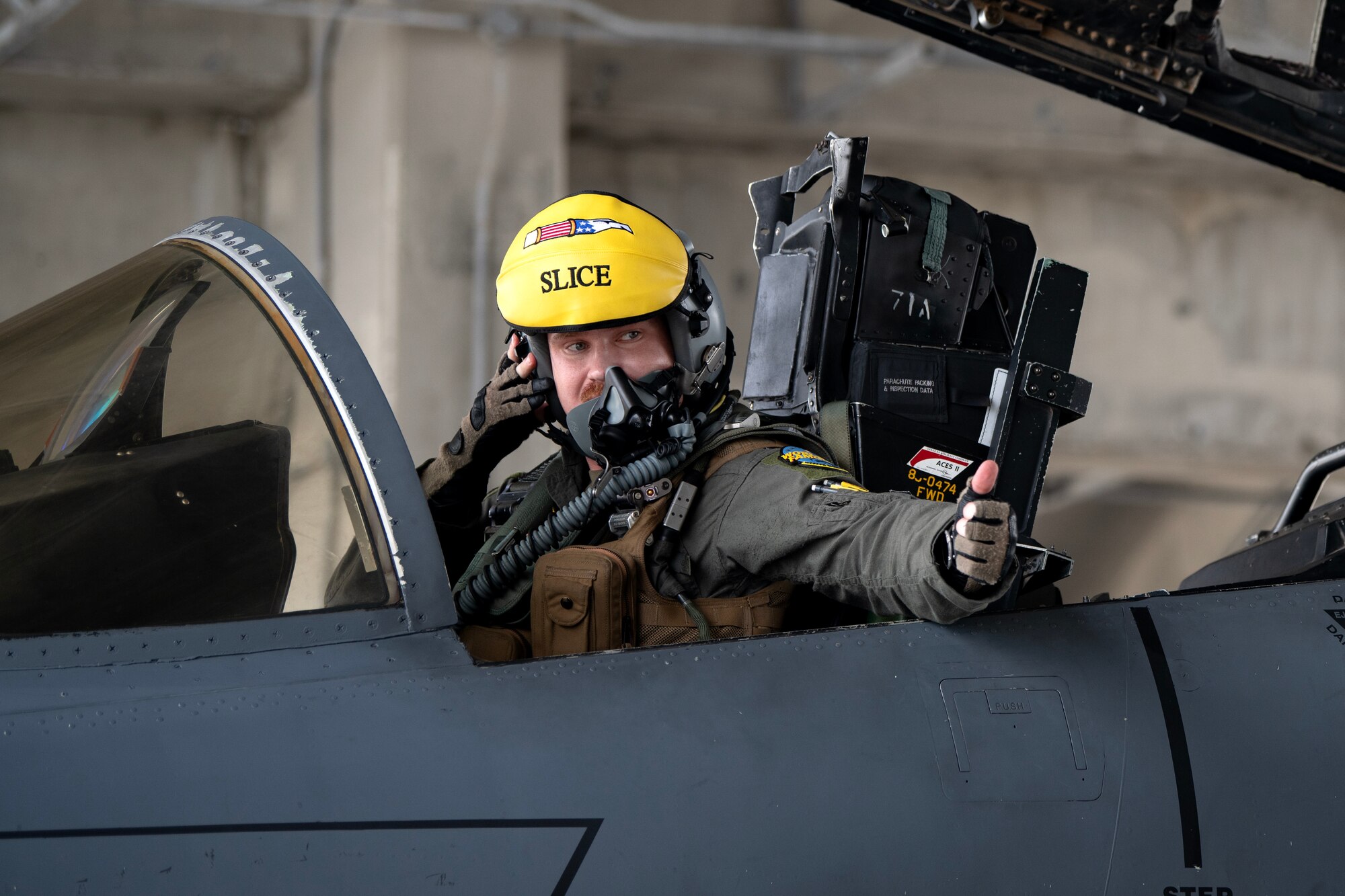 U.S. Air Force Capt. Michael Gilmartin, an F-15E Strike Eagle pilot assigned to the 336th Fighter Squadron, Seymour Johnson Air Force Base, North Carolina, signals to ground crew members at Kadena Air Base, Japan, Aug. 11, 2023. Kadena is committed to providing world-class support to strengthen regional alliances and partnerships, as well as U.S. forces’ readiness to respond when called upon. (U.S. Air Force photo by Staff. Sgt. Jessi Roth)