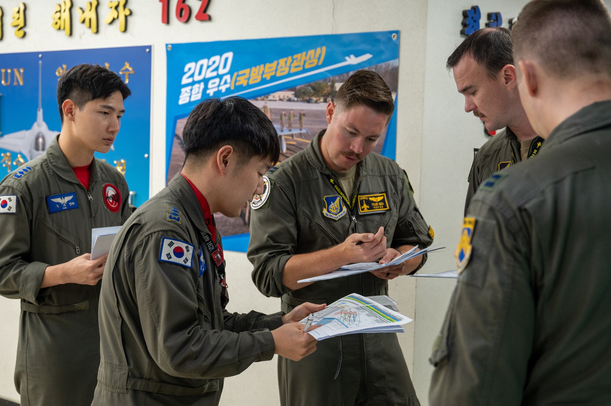 Capt. Jukyung Nam coordinates flight plans with Capt. Tyler Rico during a U.S.-ROK Buddy Squadron event.