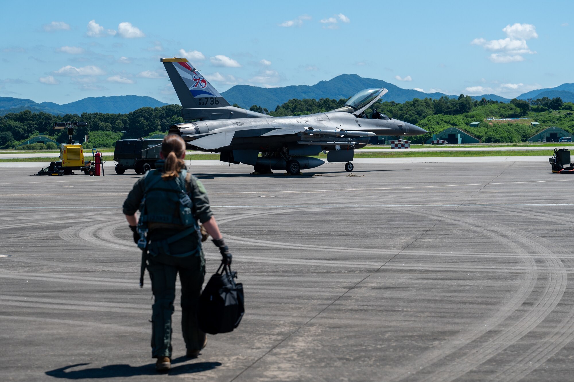 Capt. Megan Langas approaches a U.S. Air Force F-16 Fighting Falcon during a U.S.-Republic of Korea Buddy Squadron event.