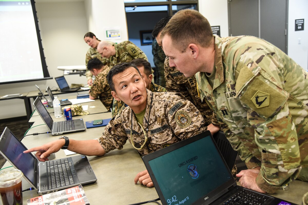 Personnel from the United States, Kazakhstan, Kyrgyzstan, Mongolia, Pakistan, Tajikistan, Turkmenistan and Uzbekistan work together Aug. 12, 2023, during Exercise Regional Cooperation 23 at the Helena Aviation Readiness Center in Helena, Montana. RC23 is an annual, multinational ,U.S. Central Command-sponsored exercise conducted by U.S. forces in partnership with Central and South Asia nations.