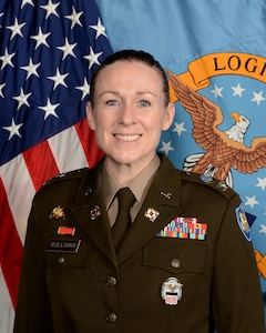 An eagle perched on an American flag shield over a blue background of 13 stars enwreathed in a gold ribbon with the words Defense Logistics Agency