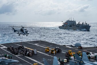 An EC-225 Super Puma attached to Military Sealift Command dry cargo and ammunition ship, USNS Carl Brashear (T-AKE 7), drops cargo on the flight deck of the U.S. Navy’s only forward-deployed aircraft carrier, USS Ronald Reagan (CVN 76), during a vertical replenishment-at-sea in the Philippine Sea, August 9, 2023.