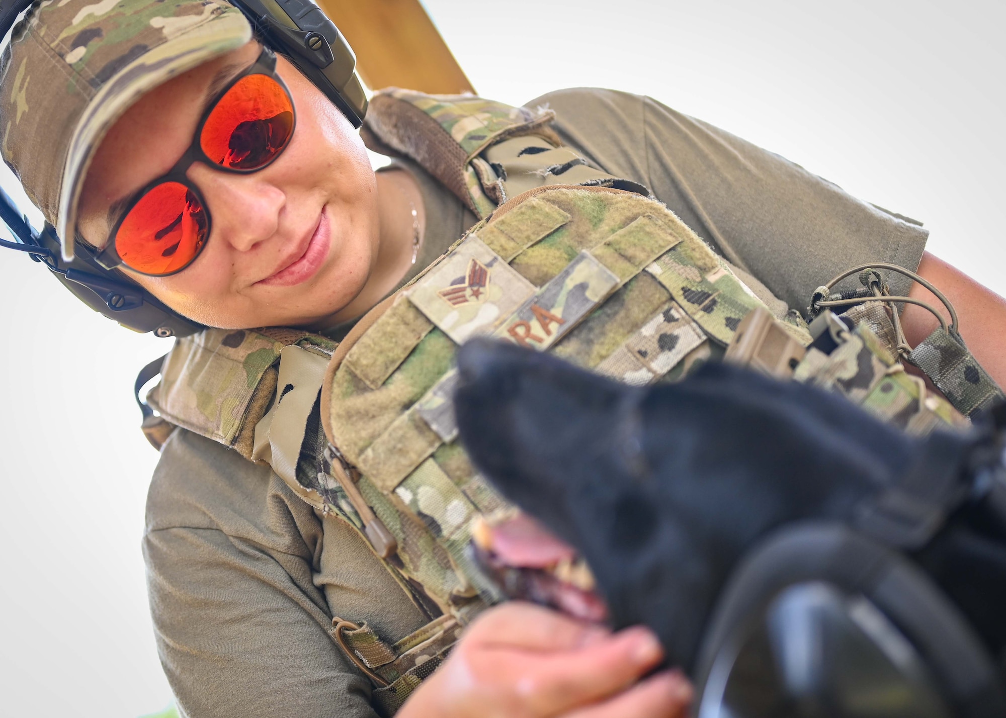 An airman greets her dog before training begins.