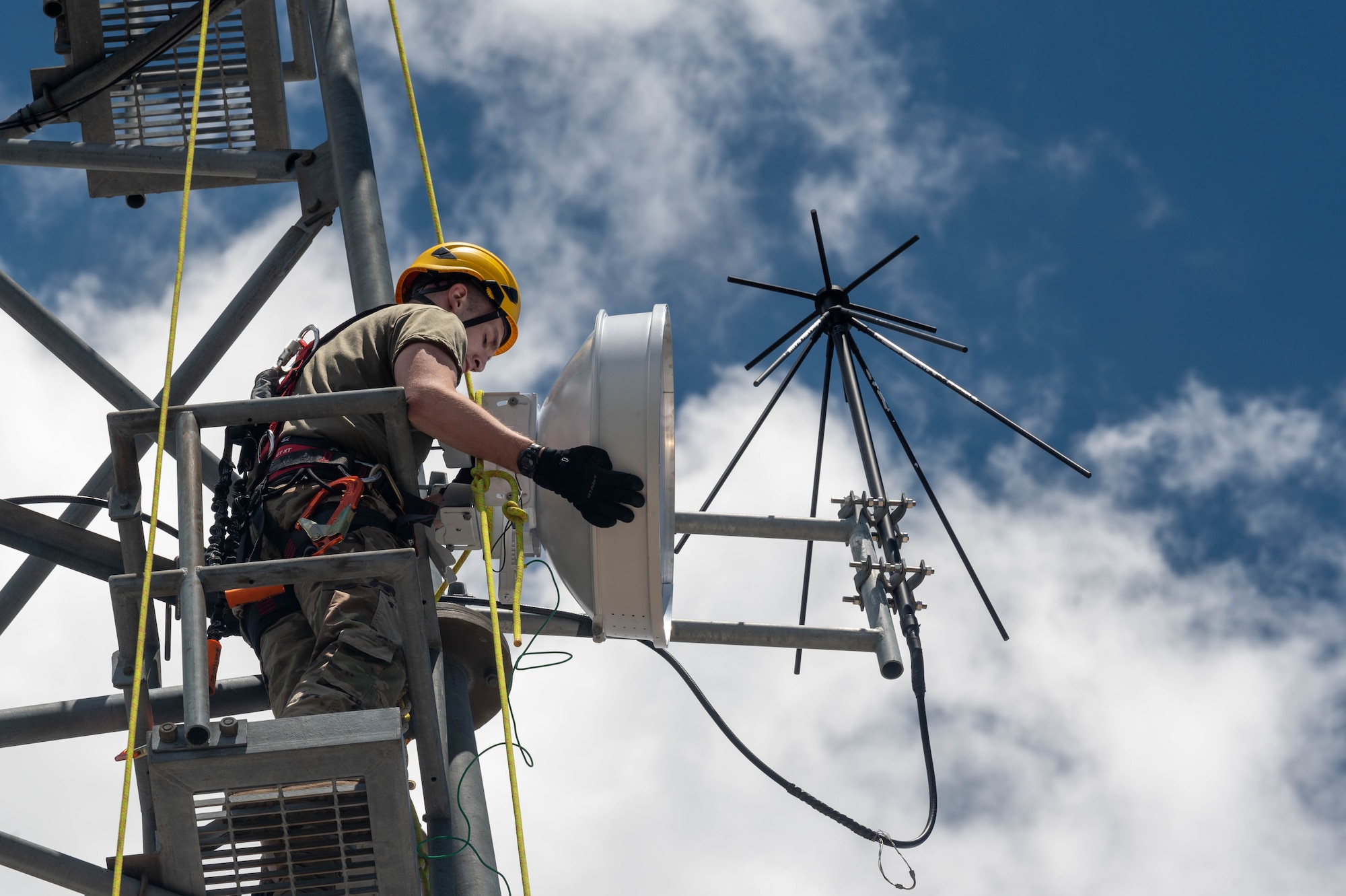 U.S. Air Force Airman 1st Class Gregory Hubof, 607th Air Control Squadron radio frequency transmission systems technician, installs a radio system Aug. 1, 2023, at Mount Lemmon in Tucson, Arizona.