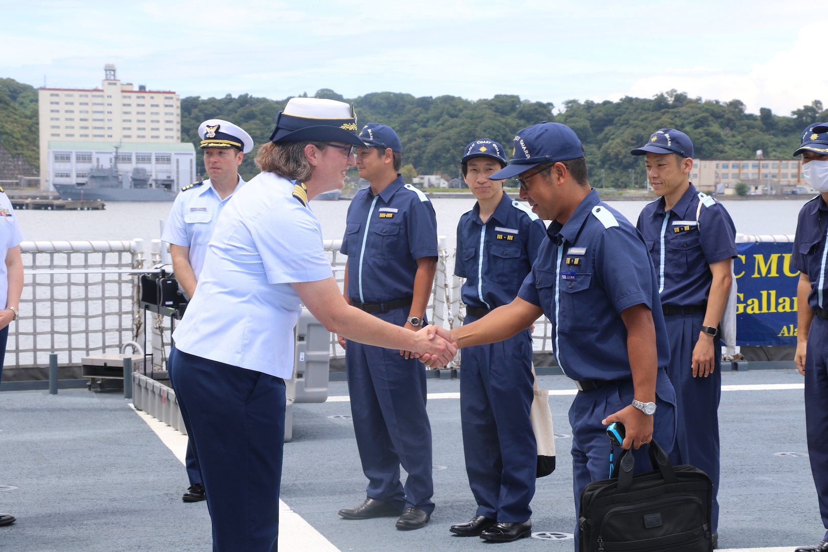 Capt. Rula Deisher, U.S. Coast Guard Cutter Munro’s (WMSL 755) commanding officer, welcomes members from the Japan Coast Guard aboard the Munro during the cutter’s port call to Yokosuka, Japan, Aug. 8, 2023. Yokosuka was Munro’s first international port call during their months-long deployment to the Indo-Pacific region. (U.S. Coast Guard photo)