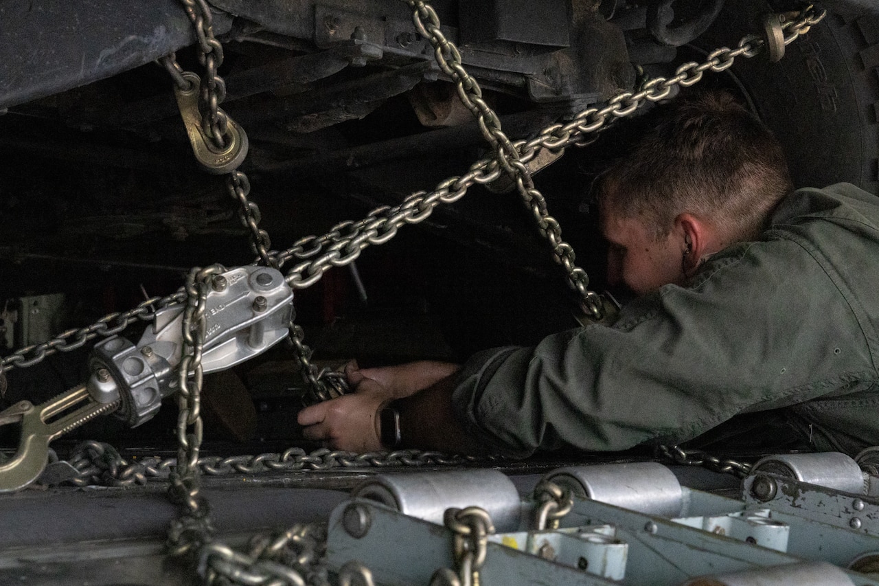 A Marine tightens chains.