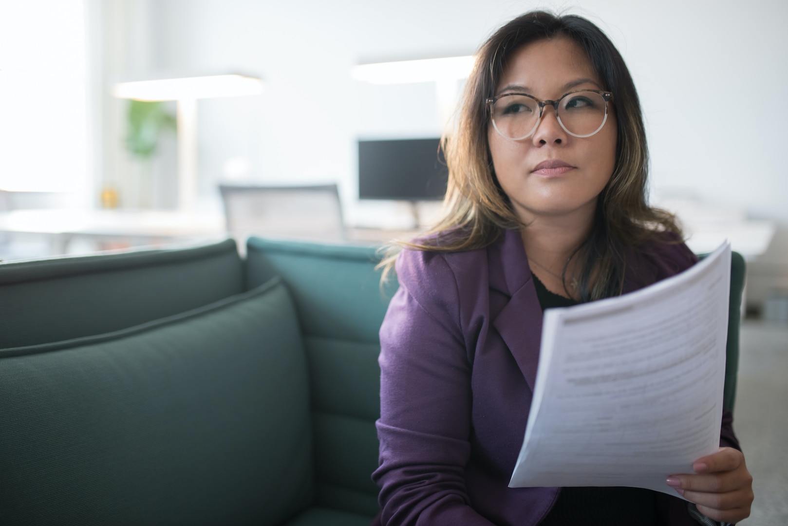 A woman reads over a document