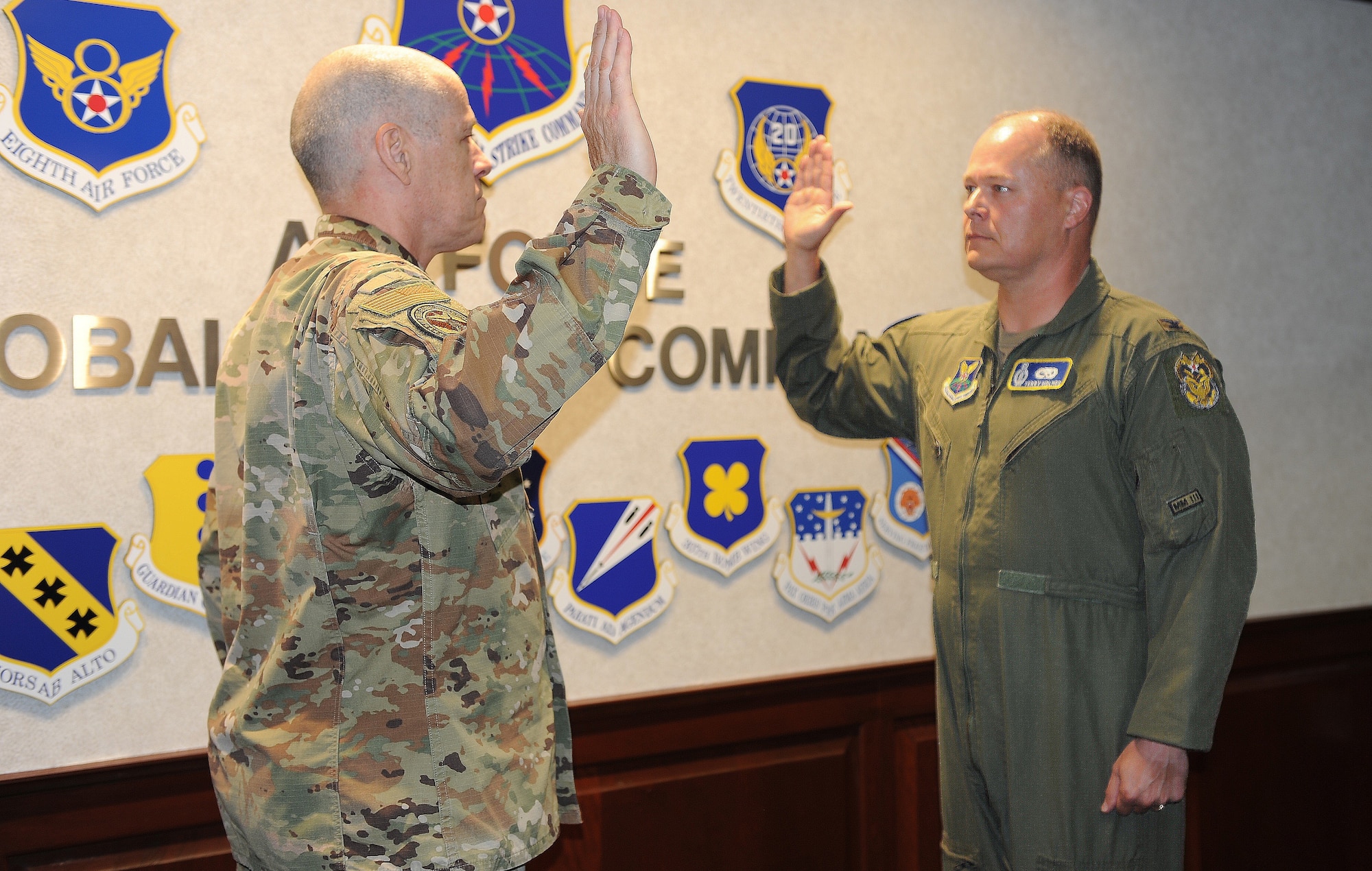 Gen. Thomas Bussiere, Air Force Global Strike Command commander, administers the Inspector General Oath of Office to Col. Terrance J. Holmes, Aug. 14, 2023.