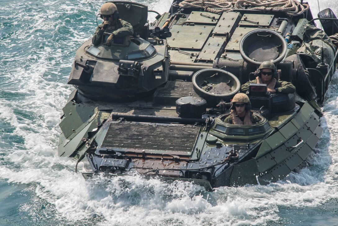 Marines aboard an amphibious assault vehicle approach the well deck of the amphibious assault ship USS Bataan (LHD 5). Bataan is the flagship for the Bataan Amphibious Ready Group and, with the embarked 22nd Marine Expeditionary Unit, is deployed in support of maritime security operations and theater security cooperation efforts in the U.S. 5th Fleet area of responsibility. (U.S. Navy photo by Mass Communication Specialist 1st Class RJ Stratchko/Released)