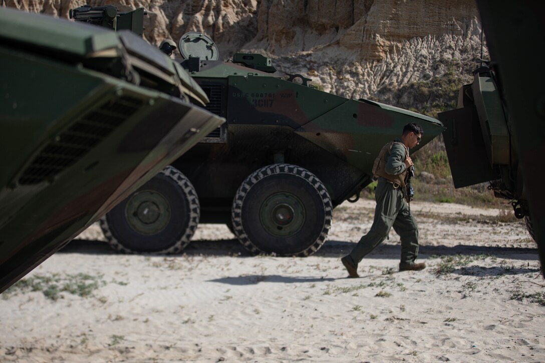 A U.S. Marine with 3d Assault Amphibian Battalion, 1st Marine Division, conducts movement on the shore after a successful training evolution at Marine Corps Base Camp Pendleton, California, March 13, 2022. The demonstration of proficiency in platoon-level operations marks the next step in certifying ACV crew members and their vehicles for worldwide deployment. (U.S. Marine Corps photo by 2nd Lt. Joshua Estrada)