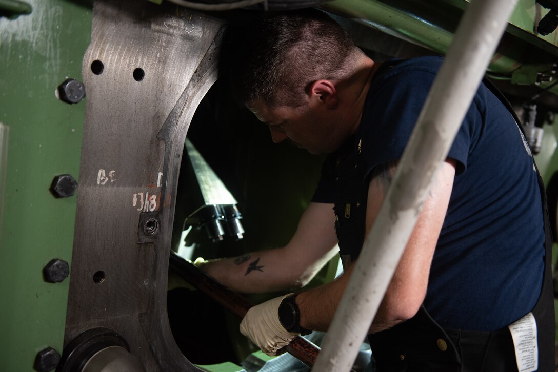 A Coast Guard Cutter Healy (WAGB 20) crew member investigates the engine’s crank shaft after experiencing a jacket water leak on a main diesel engine, to locate the source of the leak, in the Beaufort Sea, Aug. 10, 2023. Having all engines available for use is critical to the Healy’s ability to produce adequate power to break multi-year ice while simultaneously operating powerful deck and science equipment. (Coast Guard photo by Petty Officer 3rd Class Briana Carter)