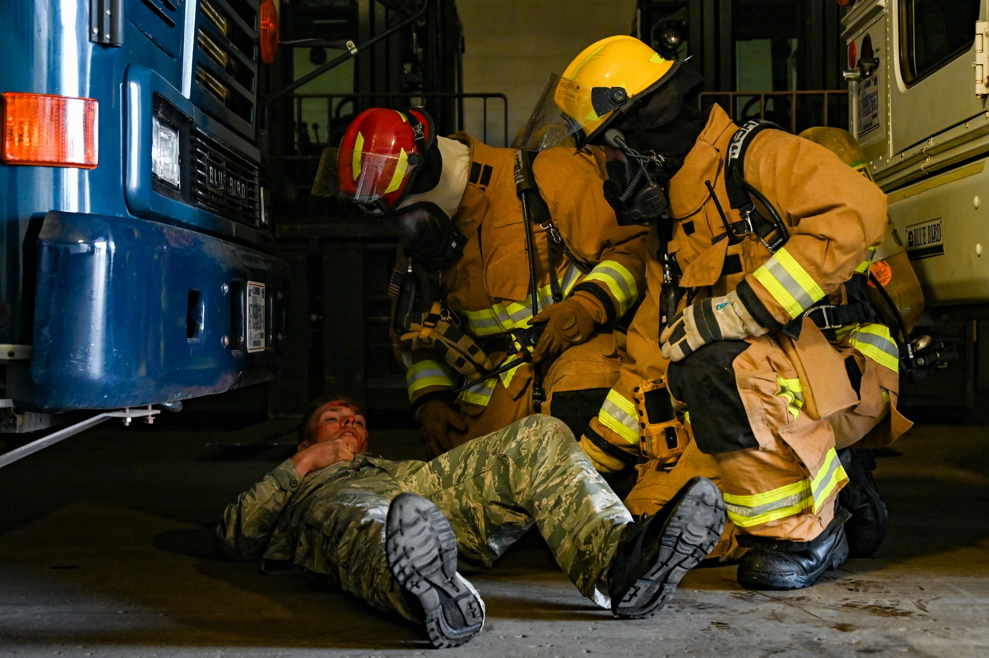 Firefighters from the 5th Civil Engineer Squadron aid a simulated-injured Airmen during the Ready Eagle exercise at Minot Air Force Base, North Dakota, Aug. 10, 2023. Ready Eagle was created to assess the response time and effectiveness of Team Minot’s first responders during a crisis. (U.S. Air Force photo by Senior Airman Zachary Wright)