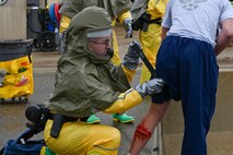 A 5th Medical Group Patient Decontamination Team first responder applies a tourniquet to a patient during Exercise Ready Eagle at Minot Air Force Base, North Dakota, Aug. 10, 2023. The exercise involved first responders, bioenvironmental teams, and field response teams.(U.S. Air Force photo by Senior Airman Zachary Wright)