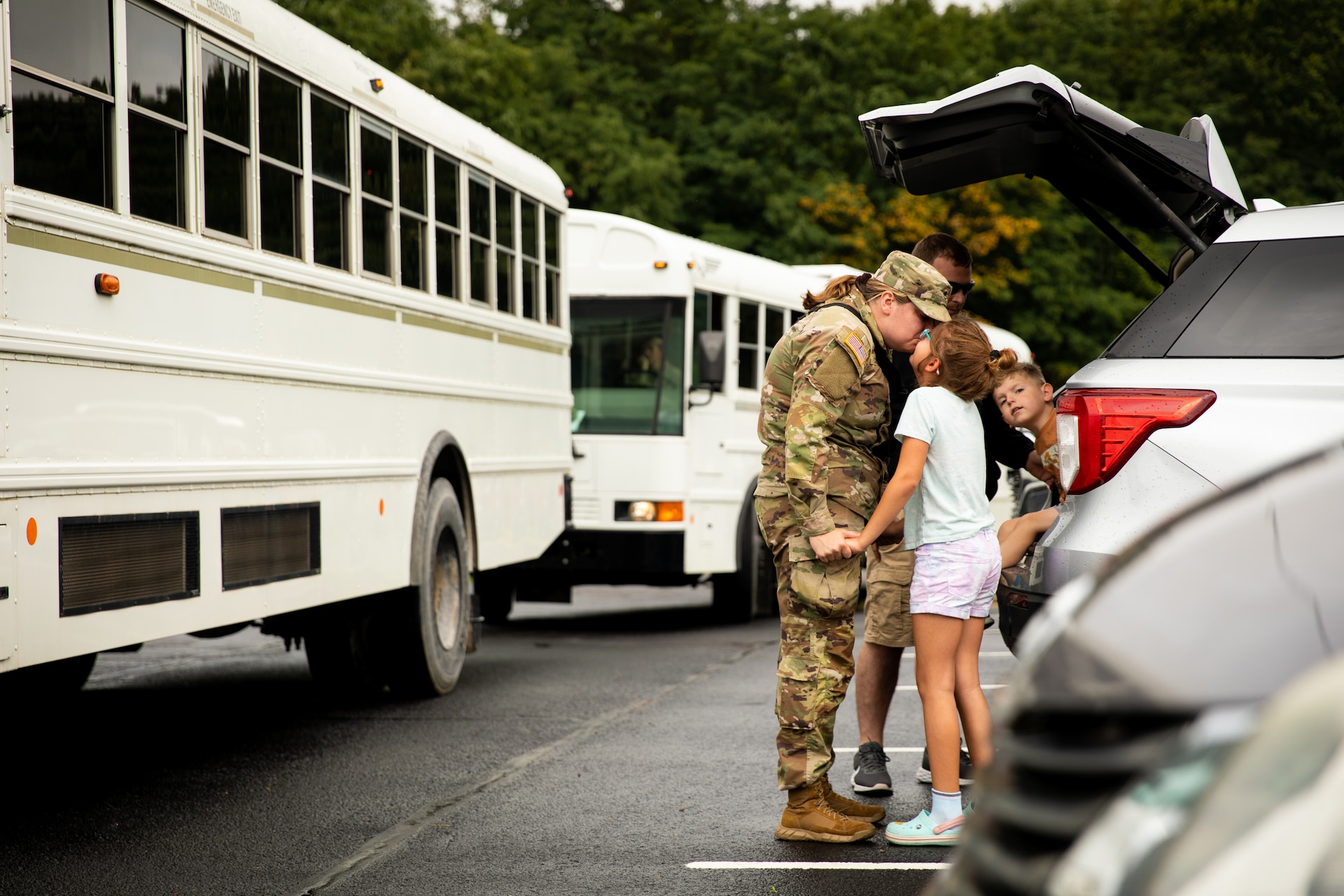 U.S. Army Staff Sgt. Adele Collin, a communications security custodian with the 138th Field Artillery Brigade, kisses her daughter before leaving the Lexington Armory in Lexington, Kentucky on August 14, 2023. Collin is with Headquarters and Headquarters Battery, 138th Field Artillery Brigade and is deploying to Southwest Asia in support of Operation Spartan Shield with the battery. (U.S. Army National Guard photo by Andy Dickson)