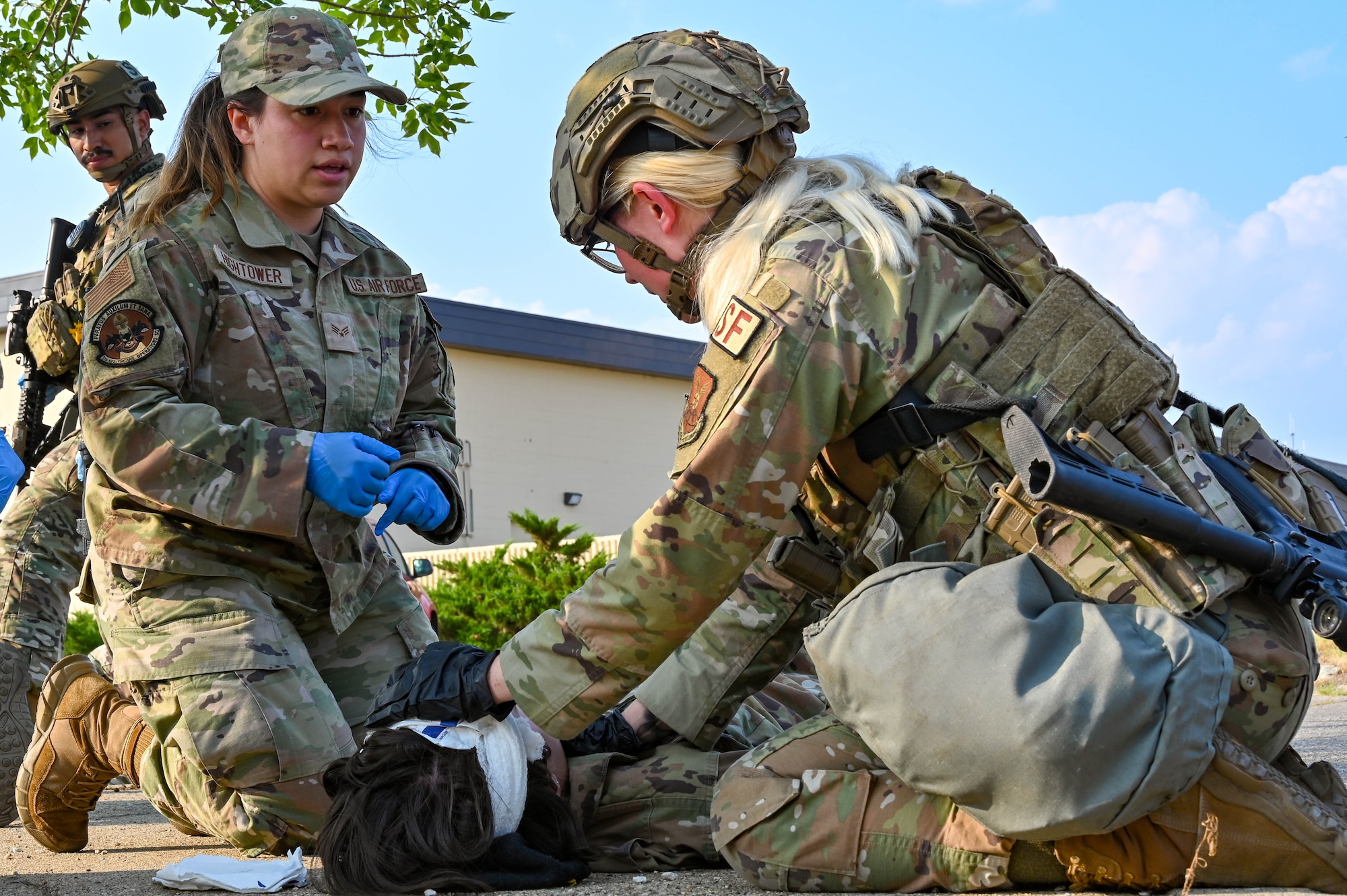 Senior Airman Olivia Hightower, first responder with the 5th Medical Group, treats a simulated injury to an Airman during an active shooter exercise at Minot Air Force Base, North Dakota, Aug. 8, 2023. Law Enforcement, Firefighters, Emergency Medical Technicians and the Air Force Office of Special Investigations all played a role in the response. (U.S. Air Force photo by Senior Airman Zachary Wright)