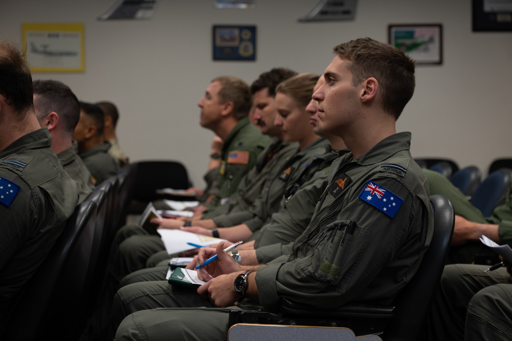 U.S. Air Force and Royal Australian Air Force flight crew members attend a pre-brief