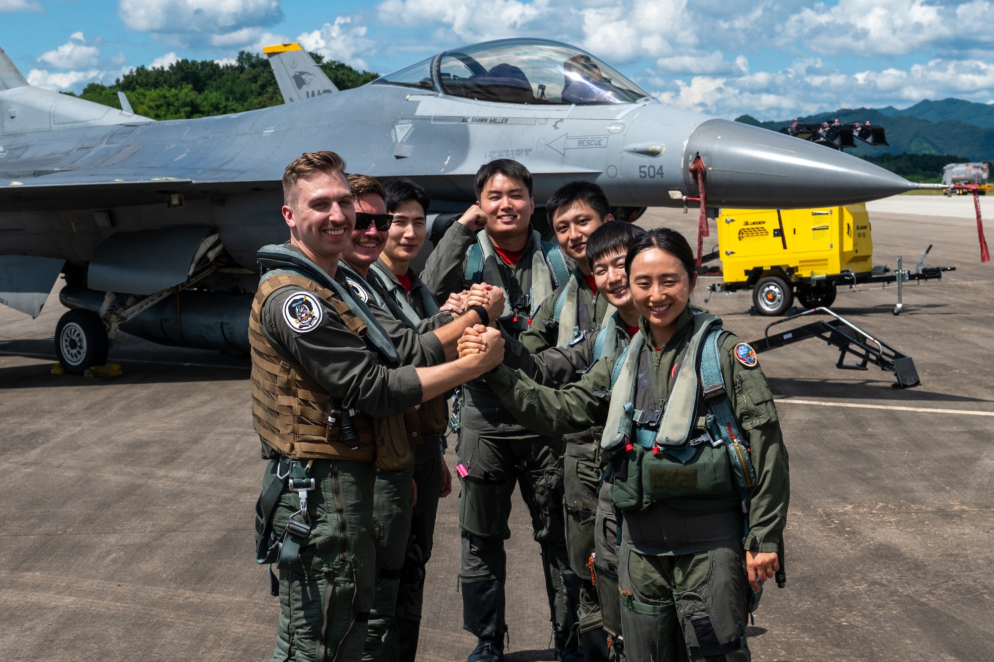 Pilots from the U.S. Air Force and the Republic of Korea Air Force clasp hands after a successful training flight during a U.S.-ROK Buddy Squadron event.