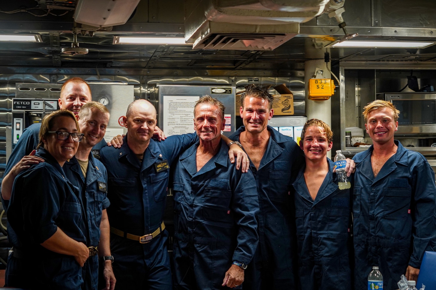 Sailors assigned to Arleigh Burke-class guided-missile destroyer USS Porter (DDG 78) pose with Ben Wiggins, Daniel Williams, Evan Williams, and Luke Lodge (left to right) after rescuing the divers at sea off the coast of Wilmington, N.C. Porter’s assistance in rescuing the divers is an example of the U.S. Navy’s unique multi-role mission to ensuring safety at sea.
