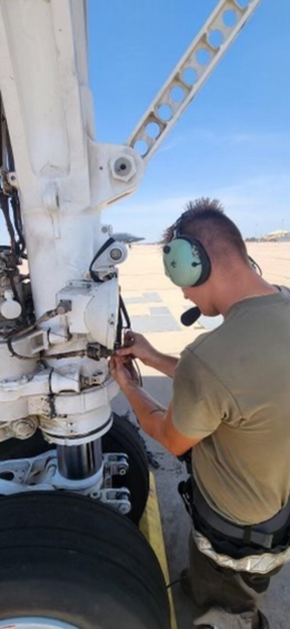 A 7th Aircraft Maintenance Squadron Airman plugs a wireless central communication gateway into a B-1B Lancer.