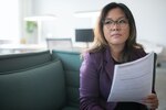 A woman reads over a document