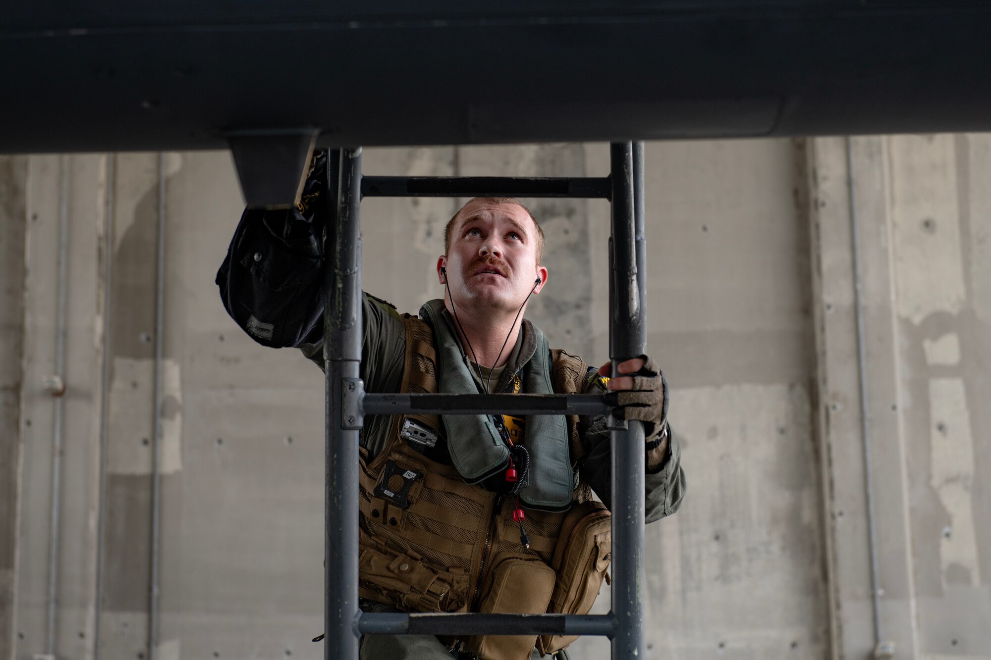 U.S. Air Force Capt. Michael Gilmartin, a pilot assigned to the 336th Fighter Squadron, Seymour Johnson Air Force Base, North Carolina, climbs up to the cockpit of an F-15E Strike Eagle at Kadena Air Base, Japan, Aug. 11, 2023. Kadena serves as the Keystone of the Pacific and its location allows U.S. Pacific Forces and partner nations to work through interoperability challenges across joint, multinational, and multi-domain operations. (U.S. Air Force photo by Staff. Sgt. Jessi Roth)