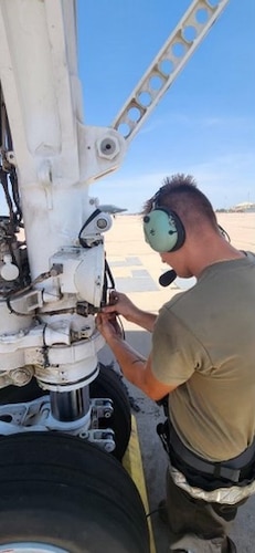 A 7th Aircraft Maintenance Squadron Airman plugs a wireless central communication gateway into a B-1B Lancer.