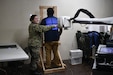 Corpsman Kelsey Redmond, navy nuclear medicine technician from the U.S. Naval Hospital Guam, continues her family’s military service tradition as she assists the radiology team at the Calvo Field House at the University of Guam during Guam Wellness Innovative Readiness Training (IRT), Aug 2-10. Guam Wellness IRT is a collaborative partnership with the Department of Public Health and Social Services that leverages military contributions and community resources to multiply value and cost savings for participants. The Guam IRT provides no cost healthcare services, ranging from medical, dental, optometry, and immunizations, to the communities of Guam, Aug. 2-10, 2023. (U.S. Army Reserve Photo by Maj. Chelsea Kersten)