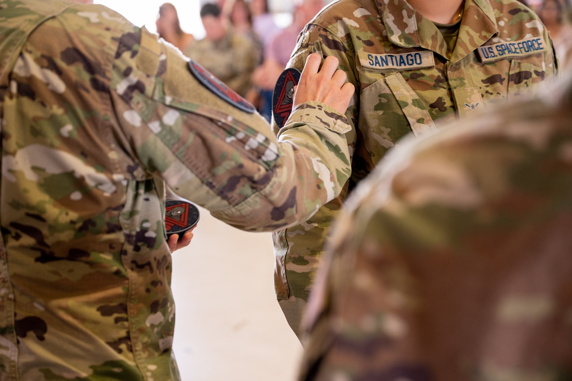 A picture of someone placing the 75th Intelligence, Surveillance and Reconnaissance Squadron patch onto the shoulder of a 75th ISRS service member