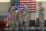 Col. Chris Batterton passes 192nd MXG guidon to Col. Timothy Strouse.