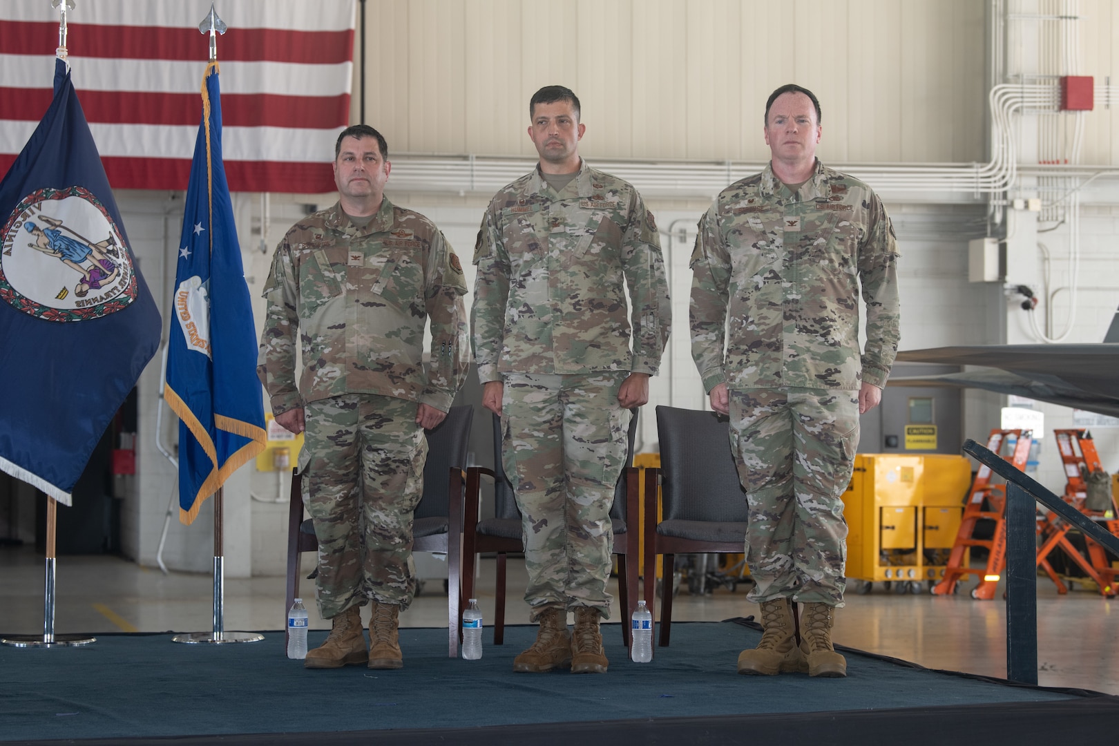 Colonels stand on stage.