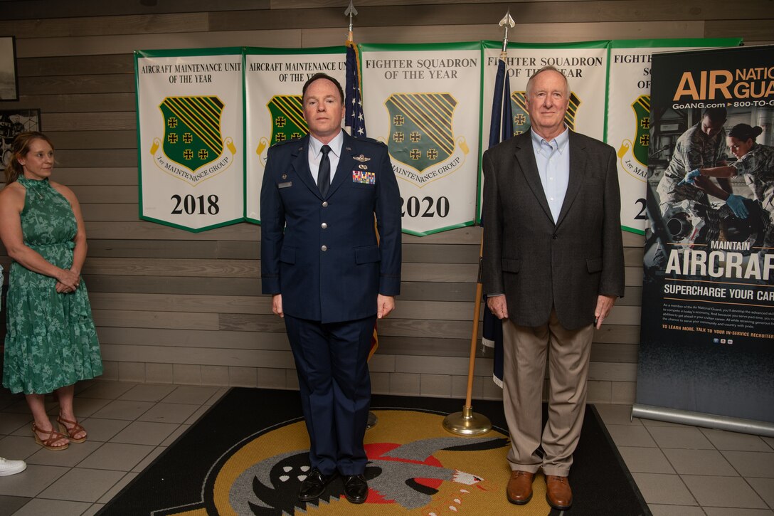 Col. Timothy Strouse and his father stand at attention.