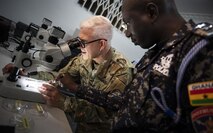 ACCRA, GHANA –– U.S. Army Col. Tom Eccles, United States Africa Command surgeon, identifies different mosquito species through a microscope with Deputy Superintendent of Police Emmanuel Baba Asabila, Ghana Police, at the Africa Malaria Task Force (AMTF) conference, July 18, 2023. The AMTF brought experts together from 25 partner nations to address best practices for detection and eradication of malaria throughout Africa, with a specific focus on the emerging threat from the invasive malaria-causing species, Anopheles stephensi.