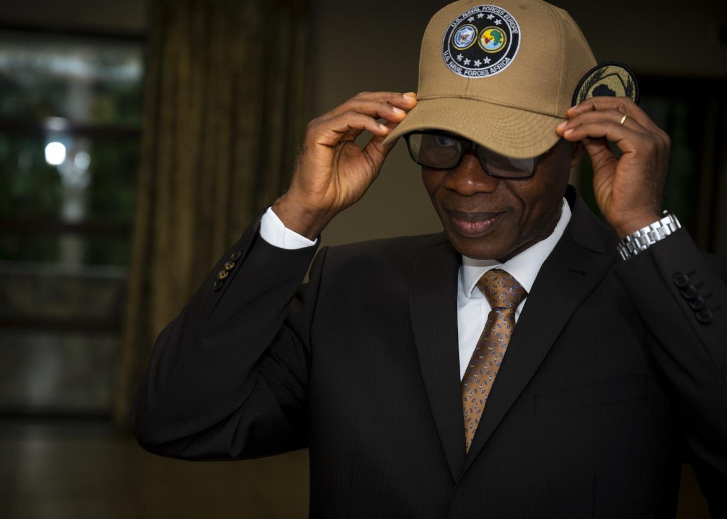 ACCRA, GHANA –– Prof. N’Dri Athanase Yao, Brig. Gen. (Ret.), dons a U.S. Naval Forces Africa, U.S. Naval Forces Africa command ball cap at the Africa Malaria Task Force (AMTF) conference, July 18, 2023. The AMTF brought experts together from 25 partner nations to address best practices for detection and eradication of malaria throughout Africa, with a specific focus on the emerging threat from the invasive malaria-causing species, Anopheles stephensi.