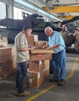 Ken Gregoire (on left) is an Army Expeditionary Civilian Workforce program employee and human resources specialist with Army Field Support Battalion-Mannheim, 405th Army Field Support Brigade. Pictured here, Gregoire assists George Parker at the Coleman Army Prepositioned Stocks-2 worksite in Mannheim, Germany. Gregoire helped recruit Palmer, who is set to become the first director of maintenance at the Long Term Equipment Storage and Maintenance-Complex in Powidz, Poland under the mission command of Army Field Support Battalion-Poland, 405th AFSB. (U.S. Army courtesy photo)