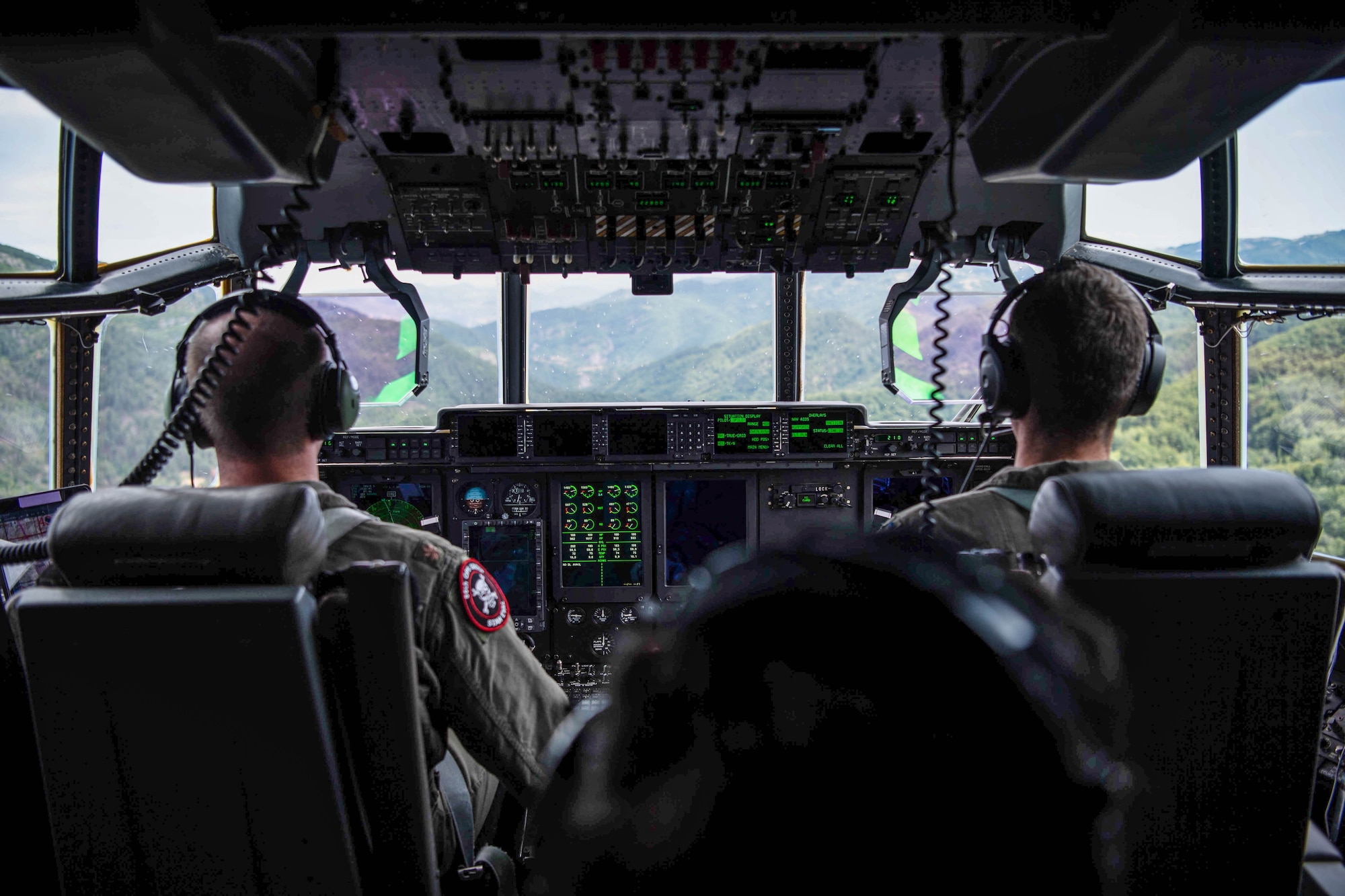 U.S. Air Force Maj. Benjamin Walker, 37th Airlift Squadron C-130J Super Hercules aircraft pilot, and 1st Lt. Brendan Towlson, 37th AS C-130J pilot, performs low level flying maneuvers over Bulgarian mountain ranges during Thracian Summer 2023 out of Bezmer Air Base, Bulgaria, Aug. 9, 2023.
